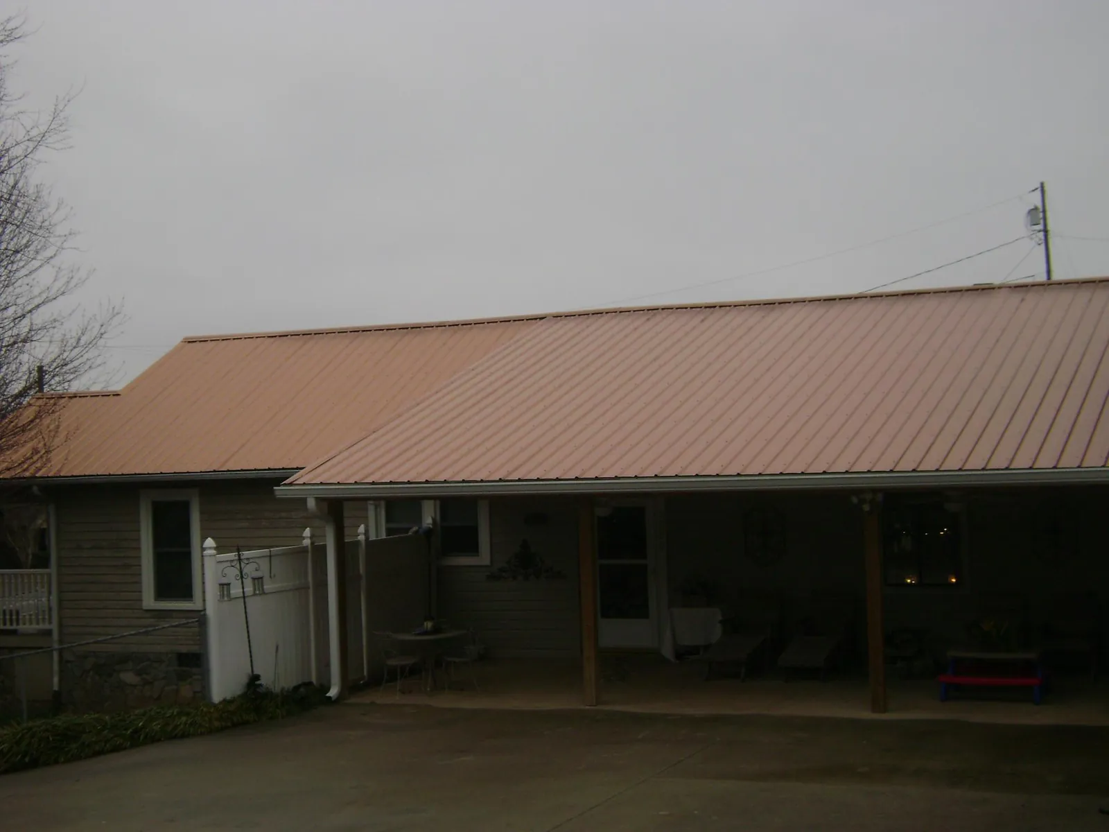 Copper toned metal roof over a wide covered patio in Fort Defiance